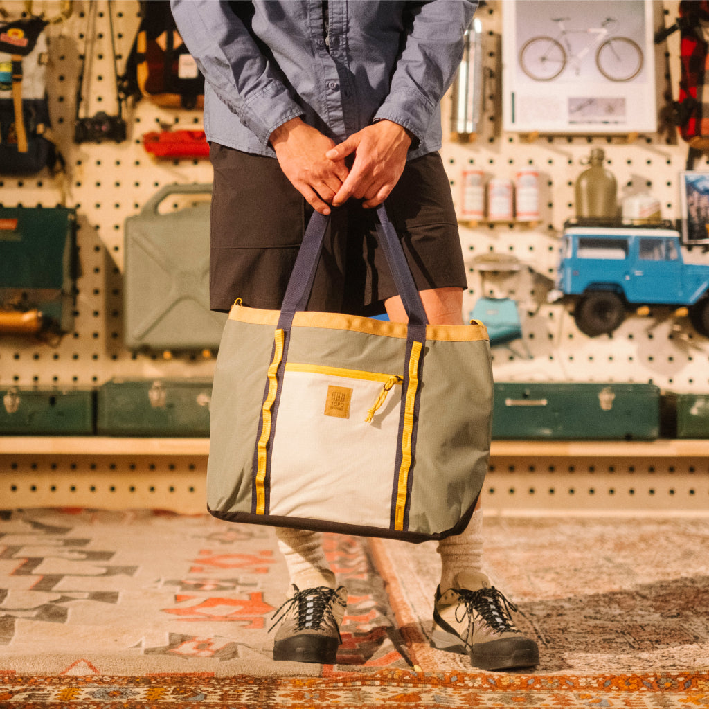 Lookbook model shot of Mountain Utility Tote in "Bone White / Beetle"